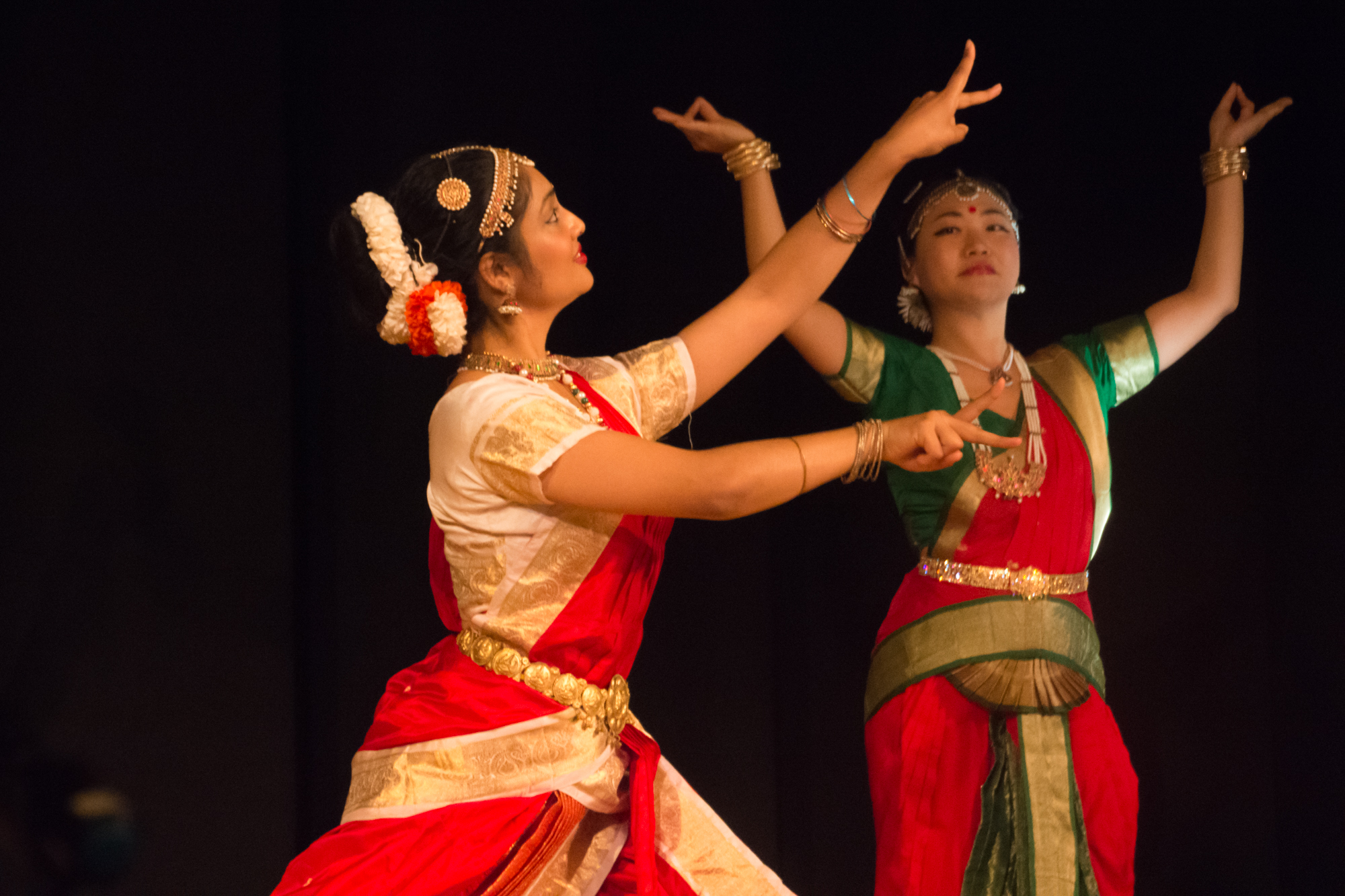 Two women performing with colorful dresses